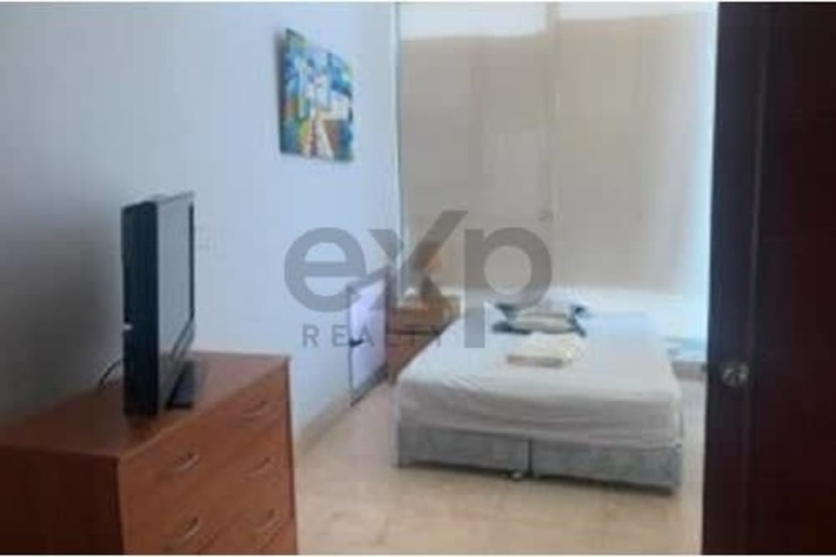 Minimalist bedroom with bed, dresser, TV, large window and blinds in PH Loft Four 41 Punta Pacifica Panama