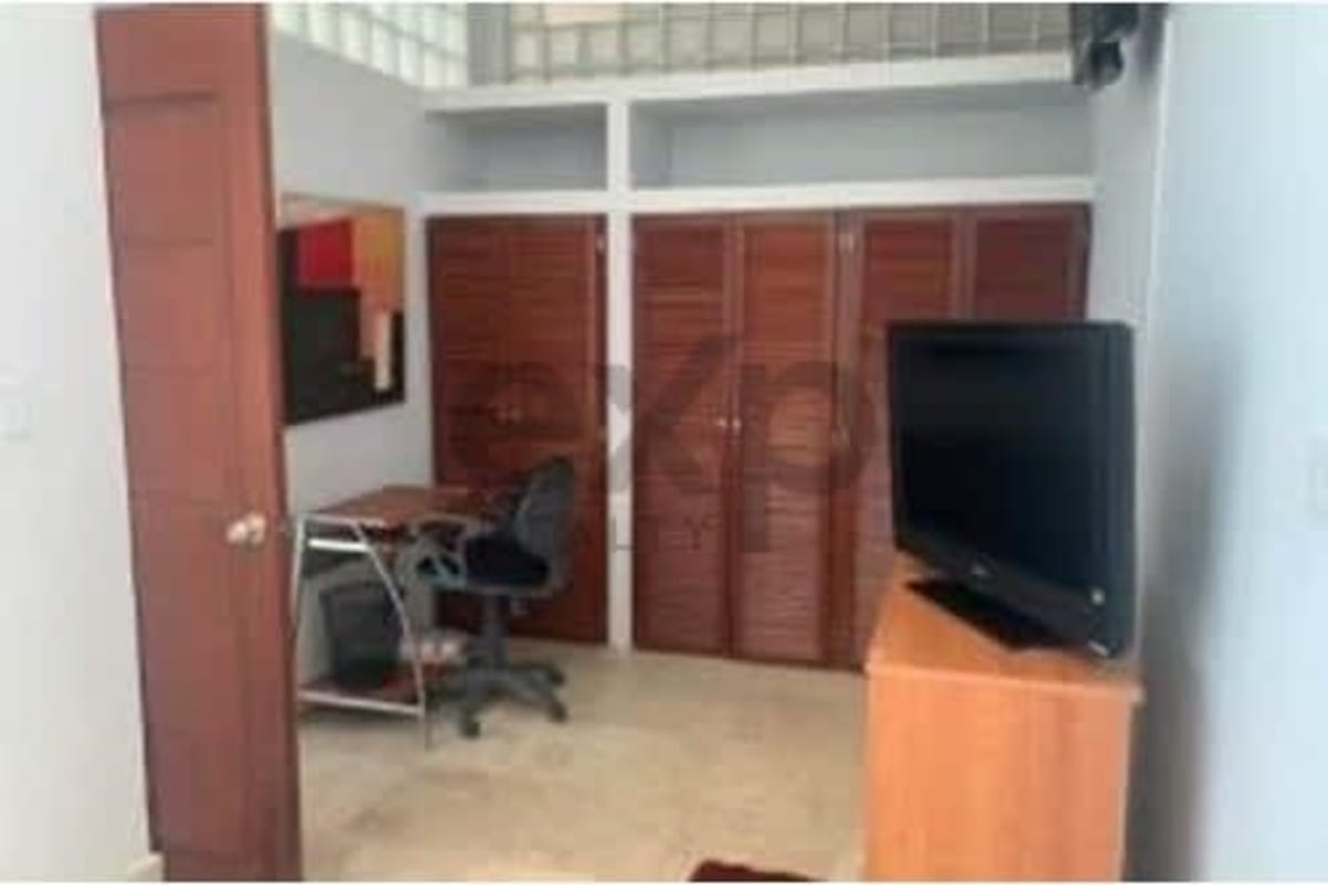 Bedroom with built-in closets, desk, flat-screen TV urban condo PH Loft Four 41 Punta Pacifica Panama