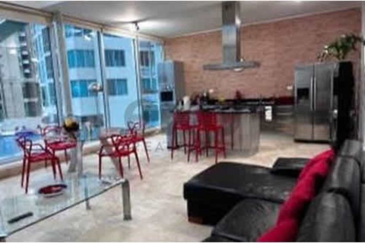 Contemporary loft-style living area with large windows overlooking Panama City skyline PH Loft Four 41