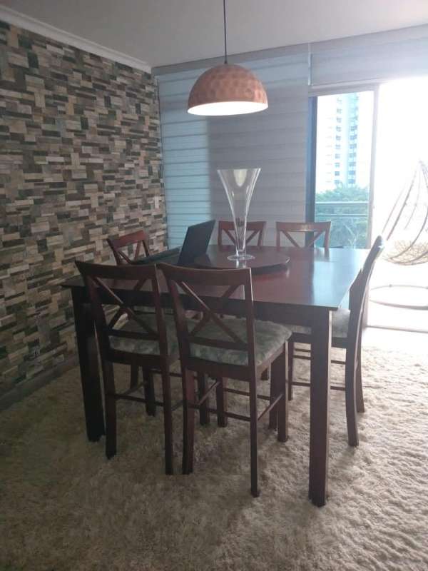 Dining area with pendant light, stone accent wall, large windows in Dos Mares Tower Panama City