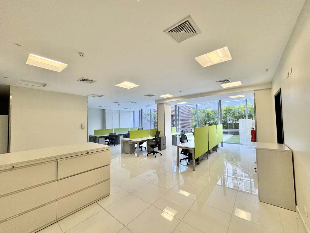 Modern office workspace with large windows, garden views, modular furniture in Costa del Este Panama