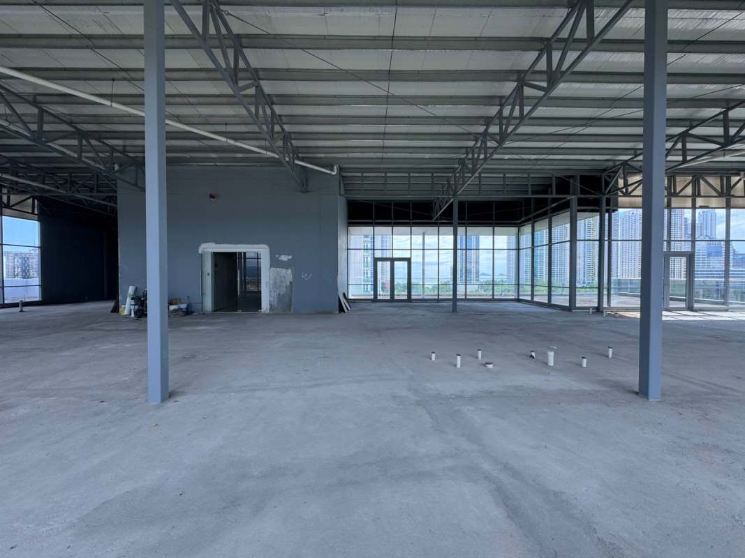 Grey shell office space with floor-to-ceiling windows showing Panama City skyline in Costa del Este