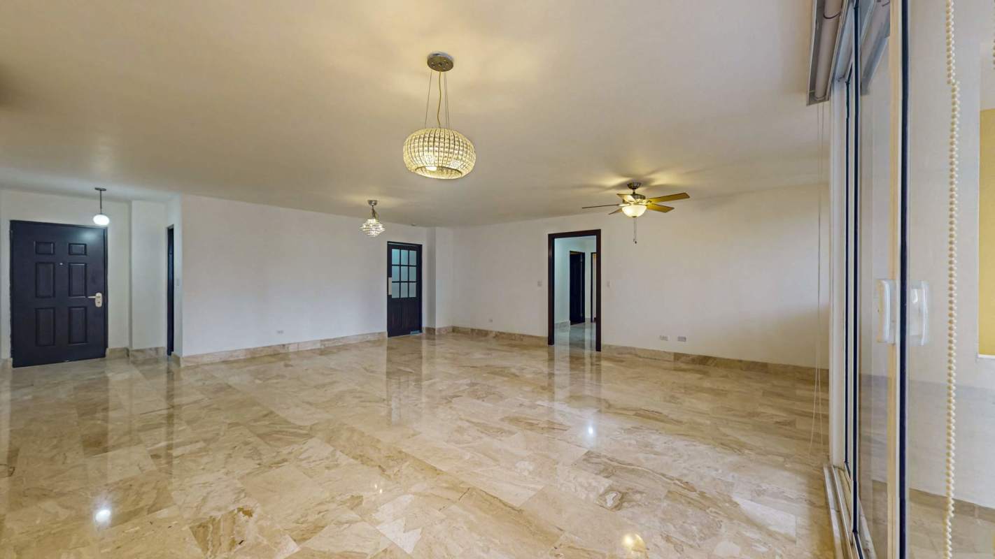 Empty luxury living room with marble floor, ceiling fan, chandelier and balcony Sophia Tower Obarrio