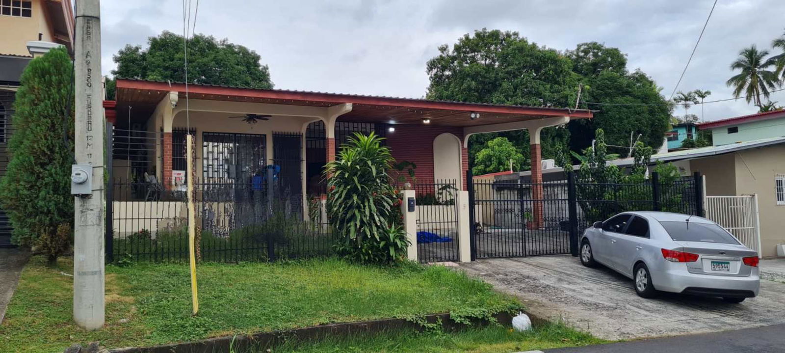 Spacious living room with wooden ceiling, large windows and fans in house Betania Panama