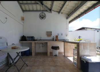 Covered patio with outdoor kitchen hammock lounge and TV in Costa Esmeralda