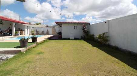 Bright living room with large tiles and windows, TV wall mount at Costa Esmeralda beach villa Panama
