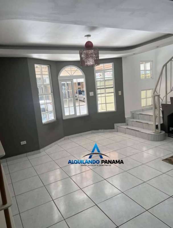 Living area with large windows, staircase, tile floor Condado del Rey Panama house for sale