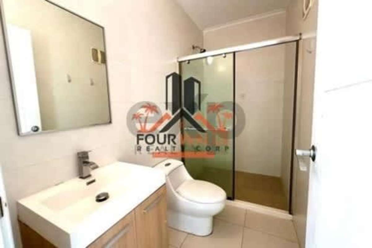 Contemporary bathroom with glass shower enclosure in PH White Tower Panama apartment