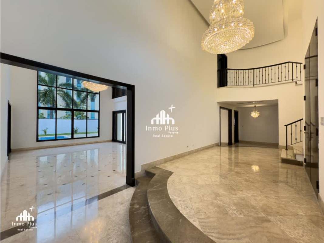 Spacious living room with marble floors, tall ceilings, chandeliers and large windows in exclusive Costa del Este rental home