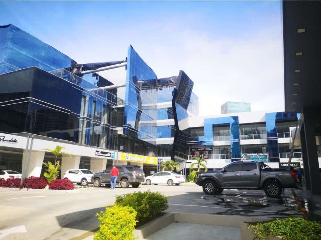 Vacant commercial rental unit with tiled floors, glass front, and suspended ceiling at Sunset Strip Mall