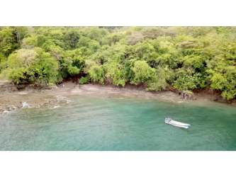 Private tropical coastline with forest and calm ocean waters on Cebaco Island Panama