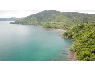 Aerial panoramic view of tropical forest and turquoise sea on Isla Cebaco land