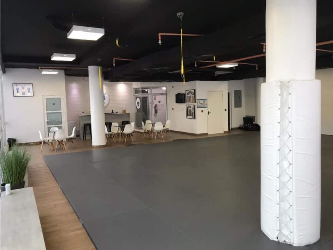 Commercial training studio with padded floors, reception seating area in BMW Center Costa del Este Panama