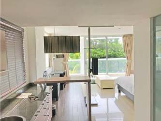 Living room with access to balcony and lagoon views in Playa Blanca condo Panama