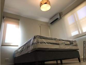 Bedroom featuring closet space and AC split unit in Woodlands house Panama Pacifico
