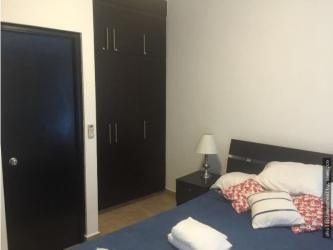 Modern kitchen with granite tops, appliances, wood cabinets at Founders III Playa Blanca Panama