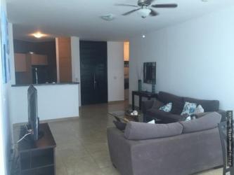 Open living dining area with access to balcony, lagoon pool view at Playa Blanca Resort Panama