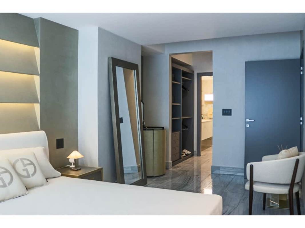 Modern bedroom with marble flooring and closet in Nuovo by Armani Casa Panama