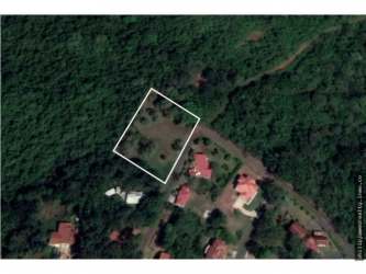 Aerial view wooded area with marked property and nearby homes Brisas de los Lagos