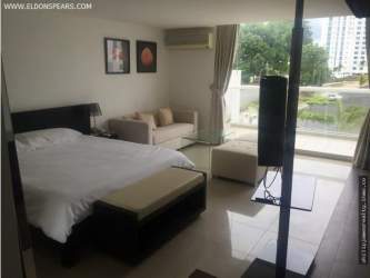Interior of studio condo with kitchenette, bed, and living space in Playa Blanca Town Center