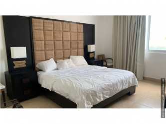 Living area with large sliding doors opening to ocean-view balcony at Nikki Beach Playa Blanca Panama