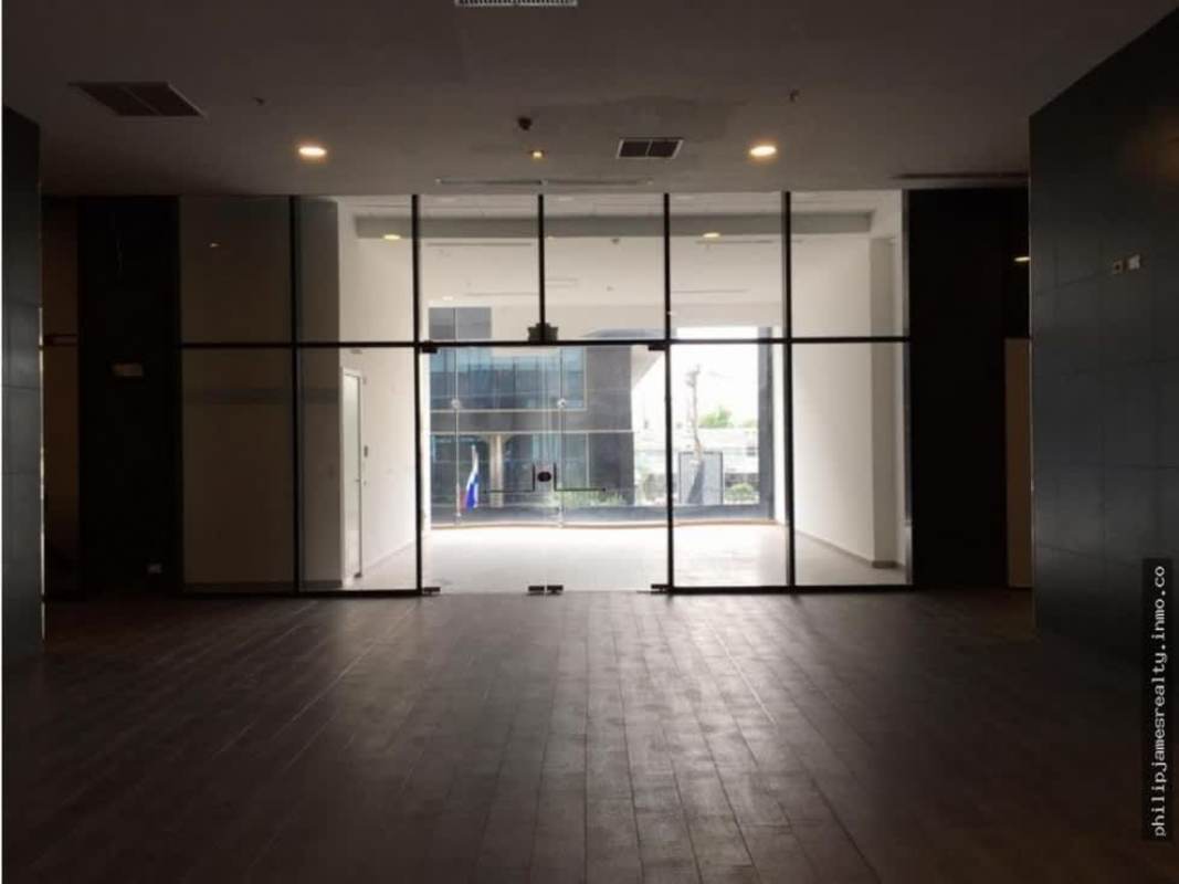 Open glass-fronted commercial space with double doors and wood style tile at Sortis Hotel Obarrio Panama City
