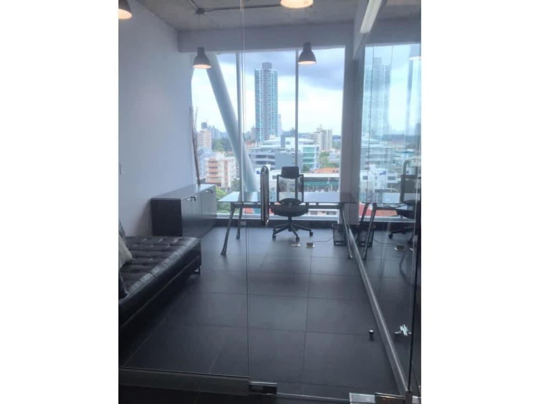 Reception desk with artwork and overhead lighting at PH Office 77 San Francisco Panama