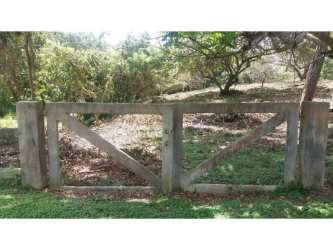 Fenced development lot bordered by concrete fence and natural greenery Punta Barco