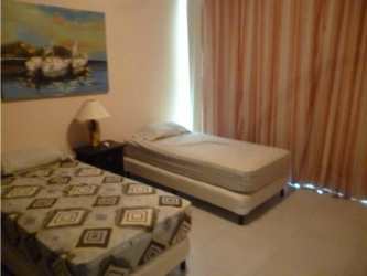 Bedroom with twin beds wall art nightstand curtains Playa Blanca condo Panama