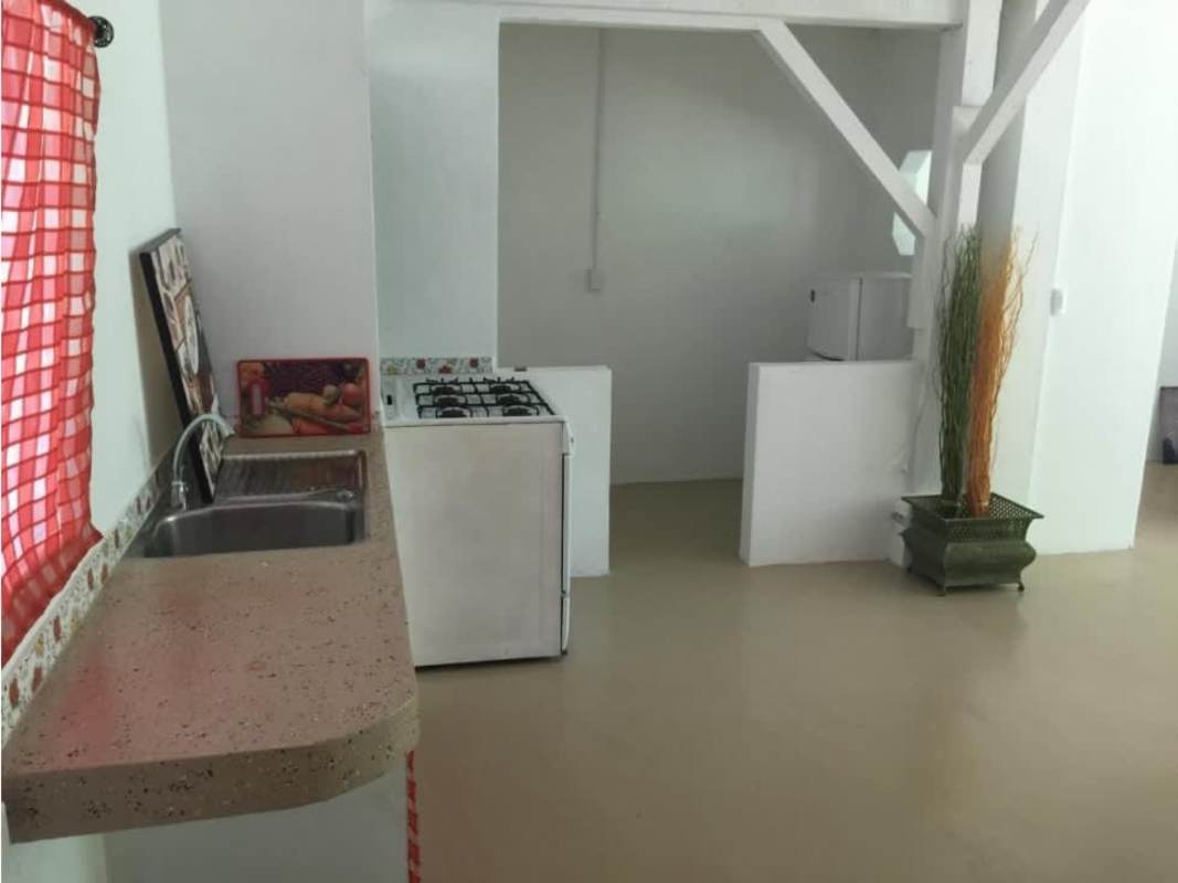 Covered balcony and patio overlooking gardens at Canal Zone villa in Panama City