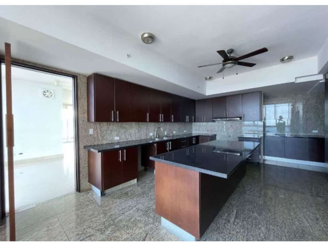 Contemporary kitchen with dark granite countertops and ceiling fan in The Point Punta Paitilla Panama City