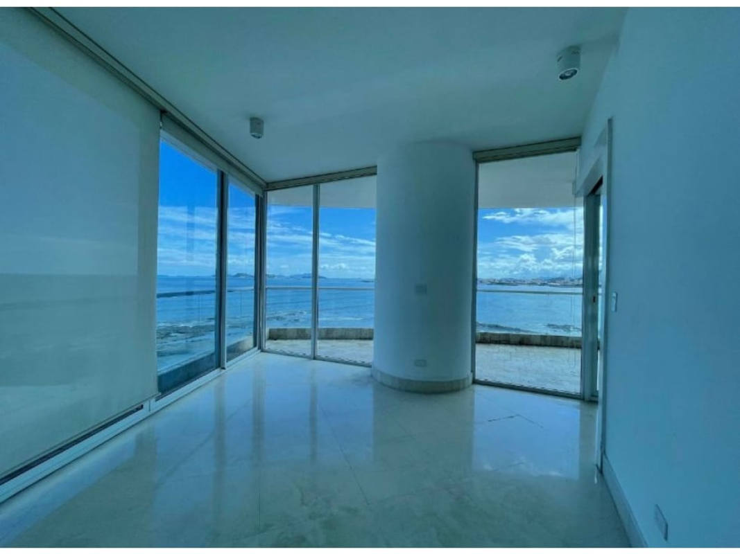 Luxury modern living room with marble floor and curved glass walls overlooking Panama Bay at The Point Punta Paitilla