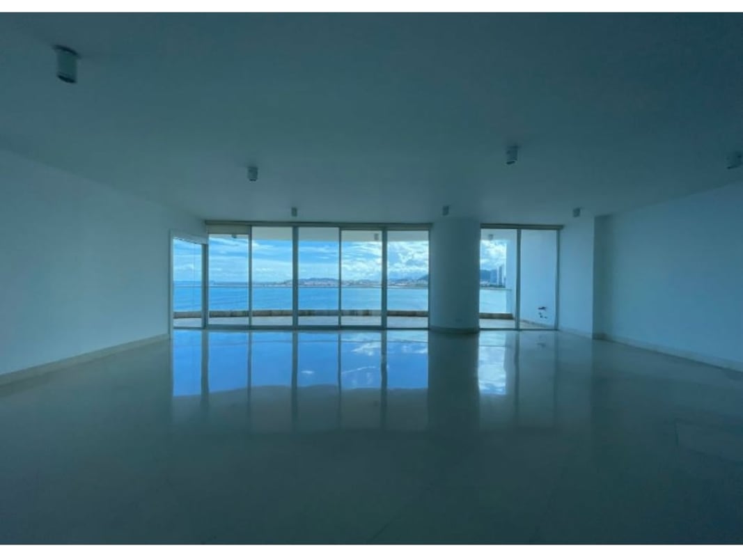 Wide living area with panoramic glass windows and ocean view at The Point Punta Paitilla Panama