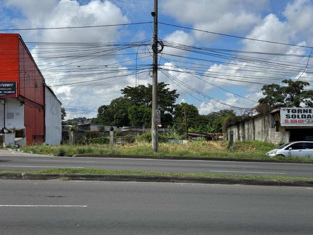 Vacant fenced commercial lot with paved main road access, power and signage near Metro in Panama