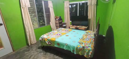Bedroom with colorful bedding and windows David Chiriquí Panama