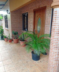 Covered porch with plants brick walls entry Los Algarrobos Chiriquí Panama