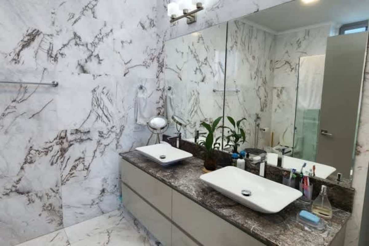 Infinity swimming pool surrounded by tropical lounge area at PH Regalia Costa del Este Panama City