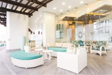 Sea view master bedroom with large windows white decor PH Malibu Residences Panama