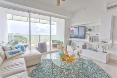 Coastal-inspired living and dining with turquoise accents, floor-to-ceiling windows ocean view PH Malibu Residences Panama