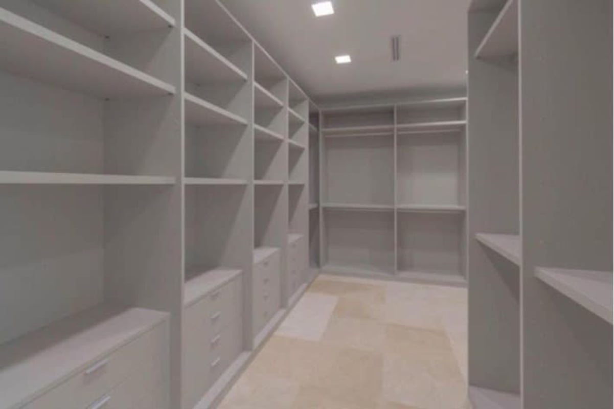 Infinity swimming pool with sun loungers and covered patio surrounded by lush tropical landscaping