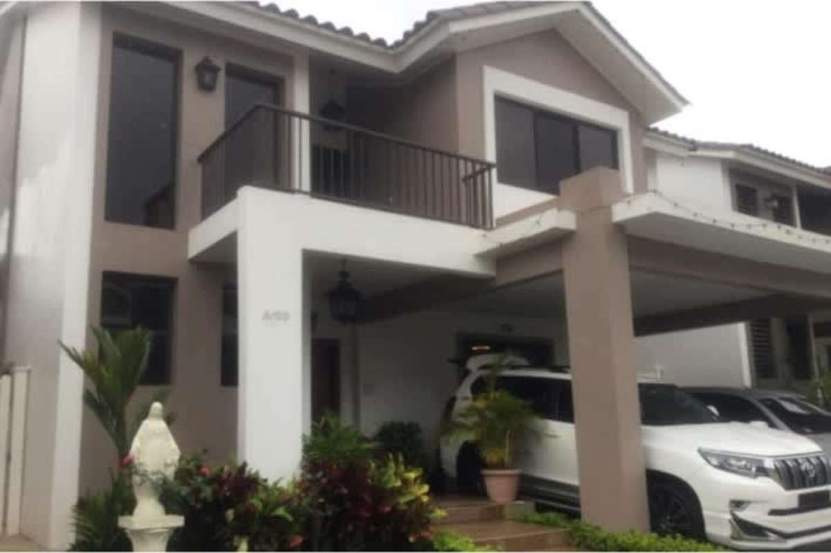 Contemporary kitchen with dark wood cabinets, granite countertops, and stainless steel appliances in Panama City