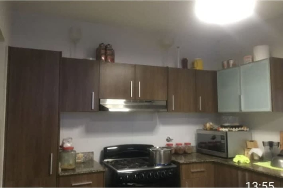 Shaded outdoor gym area with workout equipment and tile floor in Panama house