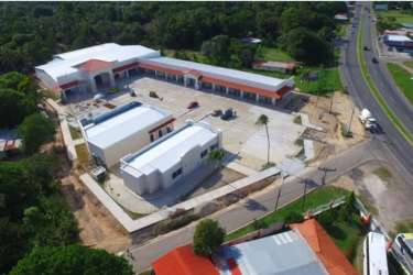 Aerial overview of commercial building with greenery and access road along Pan-American Highway in Rio Hato Panama