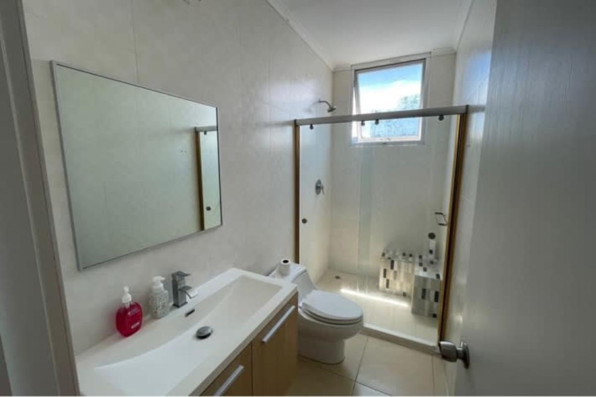 Bathroom featuring glass-enclosed walk-in shower, vanity and modern tile at PH White Tower on Avenida Balboa