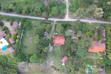 Aerial showing multiple buildings and lush acreage on beachfront land Bijao Panama