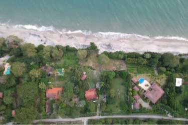 Aerial view of beachfront properties, greenery and pool in Bijao Rio Hato Panama