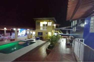 Nighttime illuminated villas with pool in Nueva Gorgona beach property Panama