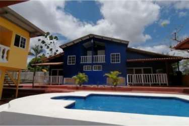 Mediterranean-inspired courtyard pool surrounded by palm trees, two-story house in Panama