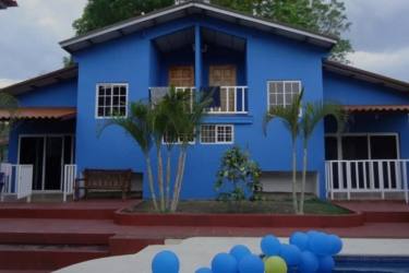 Blue-painted villa overlooking swimming pool and palm trees in Nueva Gorgona Panama