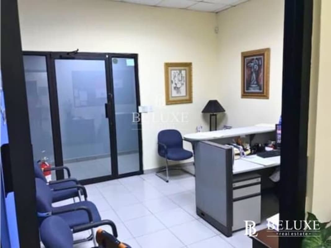 Reception office with glass sliding door, blue chairs, tile flooring, located in PH Mall 50 Panama City